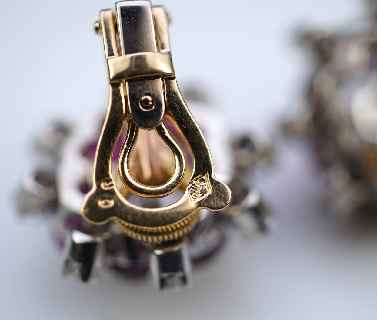 A pair of ruby and diamond ear clips, mid 20th century